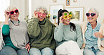 Happy, glasses and senior women face on the living room sofa for fun, playing and comedy. Smile, laughing and portrait of elderly friends or people with sunglasses, bonding and comic on the couch