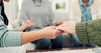 Woman, group and holding hands in support, elderly care or unity for trust, community or social gathering at home. Closeup of women touching hand in teamwork activity, understanding or collaboration