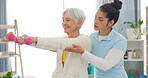 Physiotherapy, senior woman with dumbbell exercise and nurse in clinic for rehabilitation, fitness and support in healthcare. Physical therapy, help and training with a physiotherapist in hospital