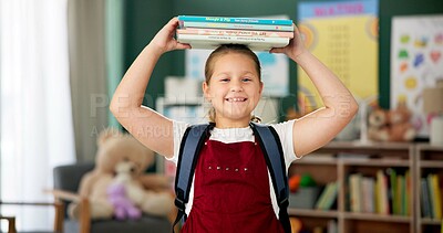 Buy stock photo Face, girl and student with books on head, smile and education with knowledge, learning and confident. Portrait, school and kid with fun, playing and childhood development with happiness and cheerful