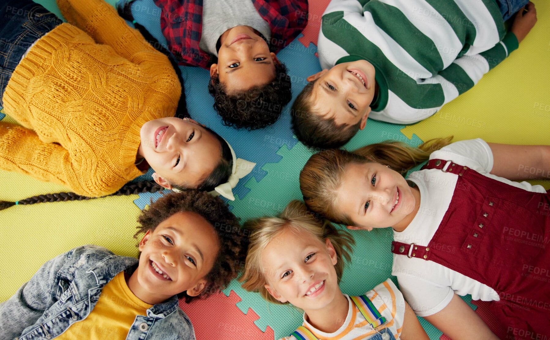 Buy stock photo Happy, kids and laying in circle on mat in school with top view for relax, fun and portrait in class. Group, children and happy on floor for education, learning and knowledge with game for bonding