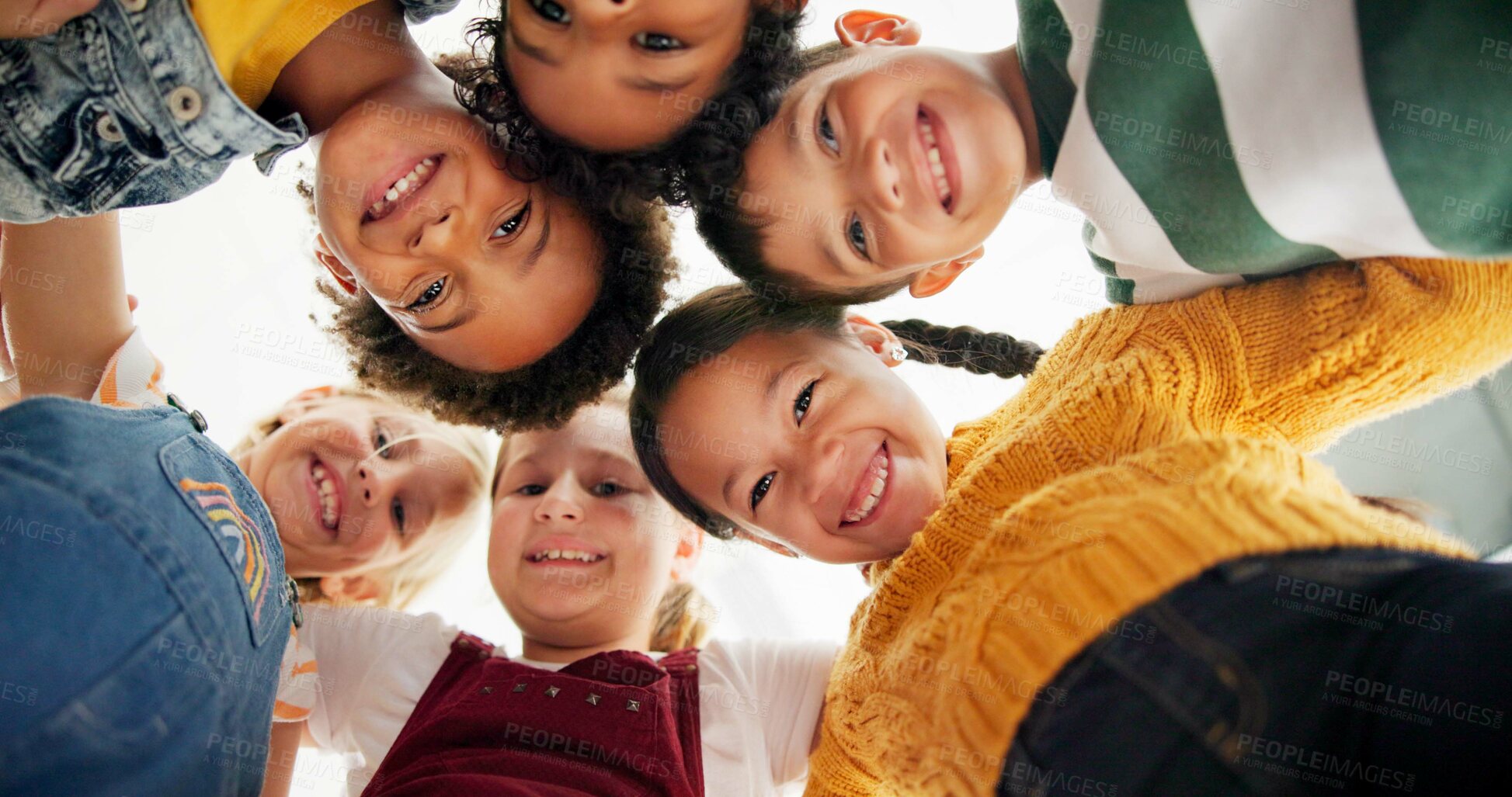 Buy stock photo Huddle, support and happy children in school for education, community or development. Low angle, diversity and group of friends with smile in playground for solidarity, teamwork or playing together