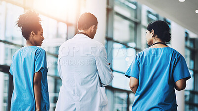 Buy stock photo Medical, team and talking on plan in hospital, walking and support or collaboration for medicine. Doctor, speaking and consulting on healthcare treatment or diagnosis, nurses and back for solidarity