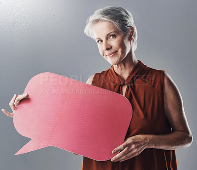 Buy stock photo Speech bubble, poster and portrait of woman in studio for news, forum and company feedback. Mockup, business and mature person with banner for info, promotion and social media on gray background