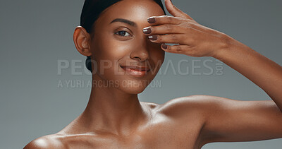 Skincare, face touch and beauty of woman in studio isolated on a gray background. Portrait, makeup cosmetics and hand of happy model in facial treatment for health, wellness and aesthetic manicure