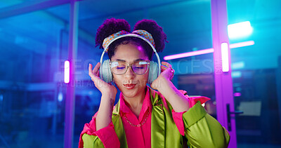 Buy stock photo Woman, night and headphones for music, glasses and dancing for motivation in office. Happy female person, hip hop playlist and movement in neon light, connection and streaming radio while working