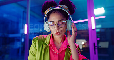 Woman, night and headphones for music, glasses and dancing for motivation in office. Happy female person, hip hop playlist and movement in neon light, connection and streaming radio while working