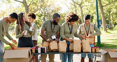 Buy stock photo Happy people, volunteer and packing with bags for charity, food and community service at outdoor park. Group or team working together in NGO with resources, supplies or mission for future in need