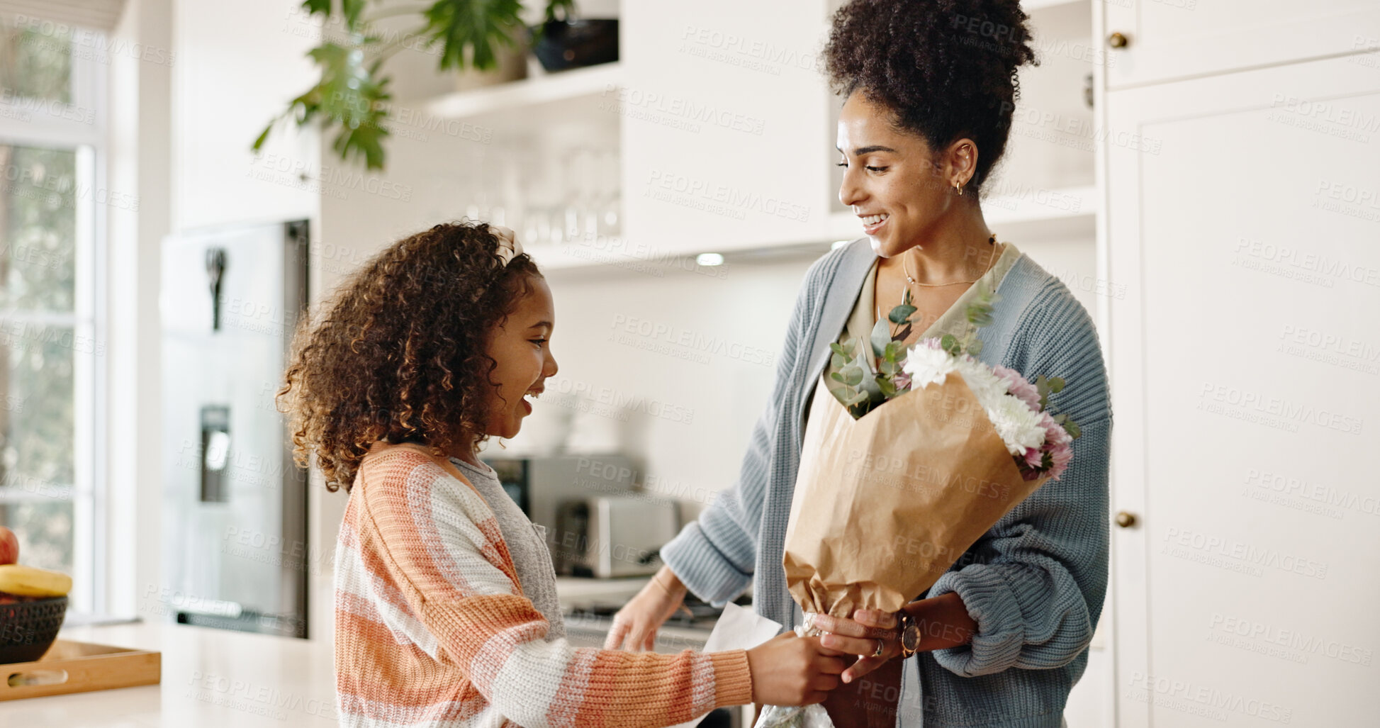 Buy stock photo Kitchen, mother and girl with gift, flowers and present for birthday, love and family in house. Home, mom and daughter with embrace, happiness and cute in apartment, woman and child with smile