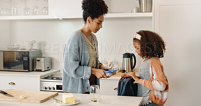 Buy stock photo Mother, child and lunchbox with backpack packing in home kitchen or nutrition, meal or morning. Woman, daughter and young student for learning development or school food for wellness, health or snack