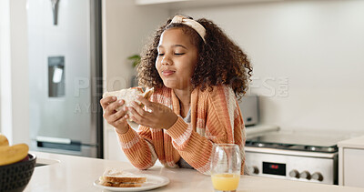 Buy stock photo Child, sandwich and eating food in home kitchen or healthy nutrition with orange juice, student or breakfast. Girl, kid and morning hungry or bread snack in apartment for fiber meal, diet or youth