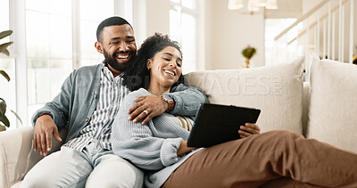 Couple, love and internet on sofa with tablet on streaming application for home entertainment, subscription and movies. Man, woman and together in house with technology on couch for online videos.