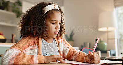 Buy stock photo Young girl, student and writing with book in kitchen for homework or assessment at home. Female person, child or kid taking notes or studying with stationery for learning or education at house