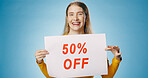 Poster, sale and portrait of woman on blue background for news, announcement and information. Shopping, advertising and happy person with sign for half price discount, deal and bargain in studio