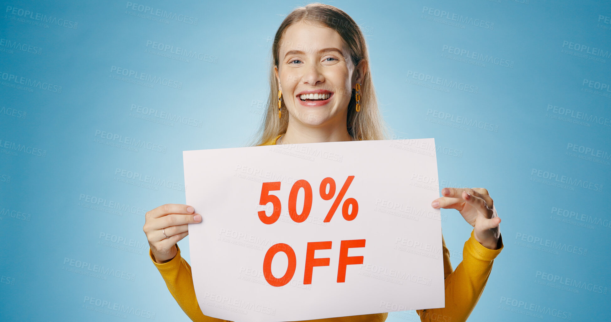 Buy stock photo Poster, sale and portrait of woman on blue background for news, announcement and information. Shopping, advertising and happy person with sign for half price discount, deal and bargain in studio