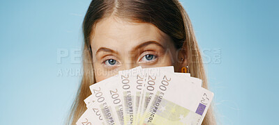 Money, winner and woman cover face in studio by cash fan, finance or bonus and credit loan on blue background. Lottery, bank and person hide for budget secret, gambling or salary increase in portrait