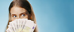 Money, thinking and woman cover face in studio with cash fan, finance or savings idea on banner mockup. Lottery, banking and person hide for budget secret, gambling or investment on blue background