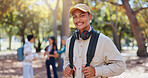 Travel, man and university park portrait on campus in New York with backpack and study break. Happy, smile and education of a post graduate student with confidence and commute outdoor with education