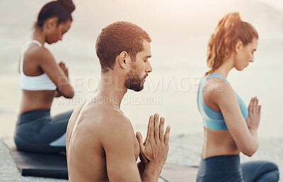 Buy stock photo Yoga, meditation and people with prayer on beach for wellness, workout and mindfulness in nature. Pilates, mental health and men and women in praying pose for meditation, peace or spiritual awareness