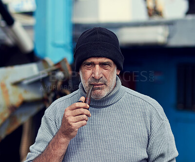 Buy stock photo Cropped shot of an elderly fisherman smoking his pipe