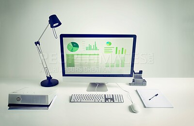 Buy stock photo Workspace, computer screen and notebook in room with light for remote work, infographics or data analytics. Workplace, monitor and documents on desk with keyboard for financial career and statistics