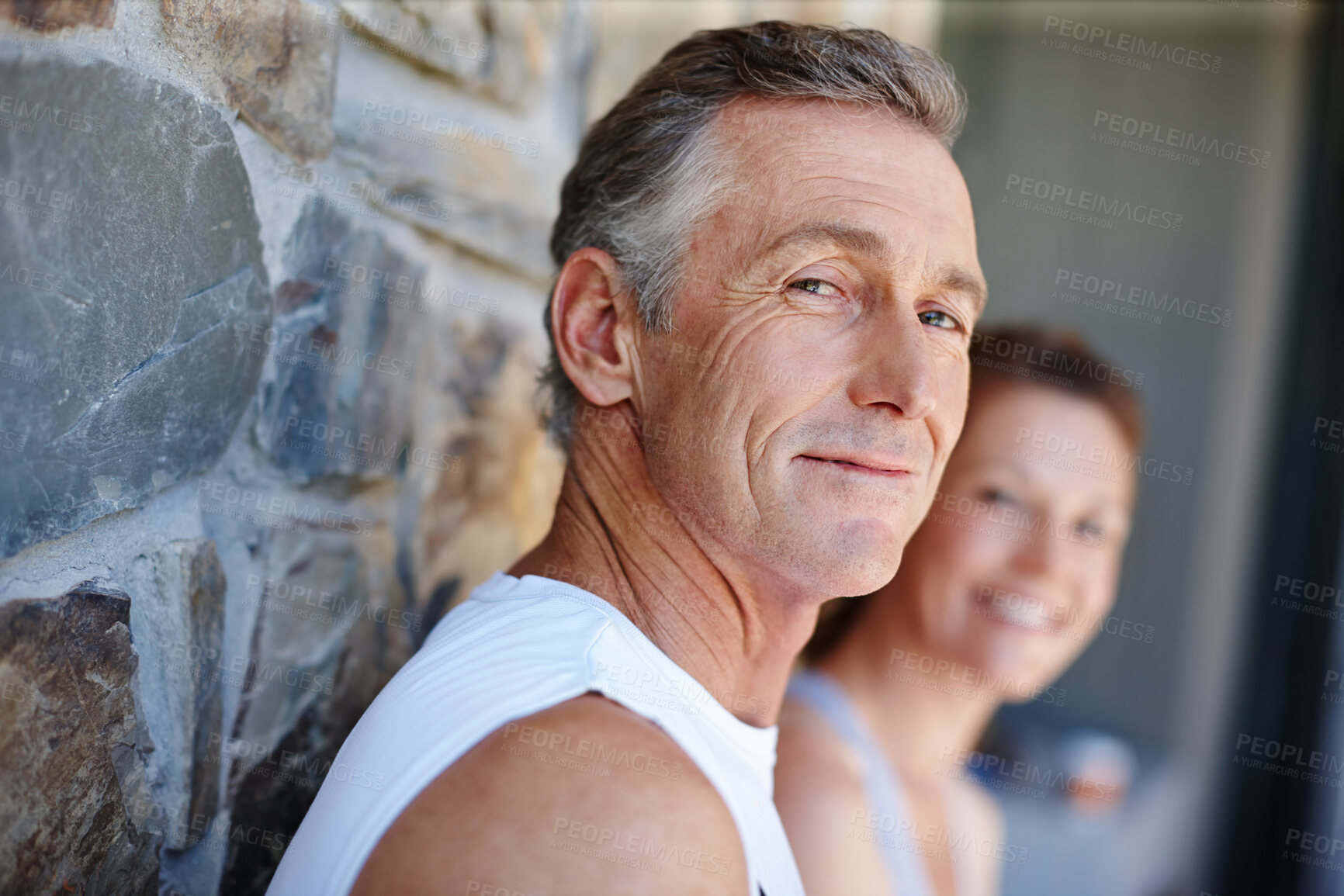 Buy stock photo Fitness, portrait and smile with mature couple outdoor on brick wall for running or training together. Exercise, cardio and face of man with woman at start of daily workout routine to improve health