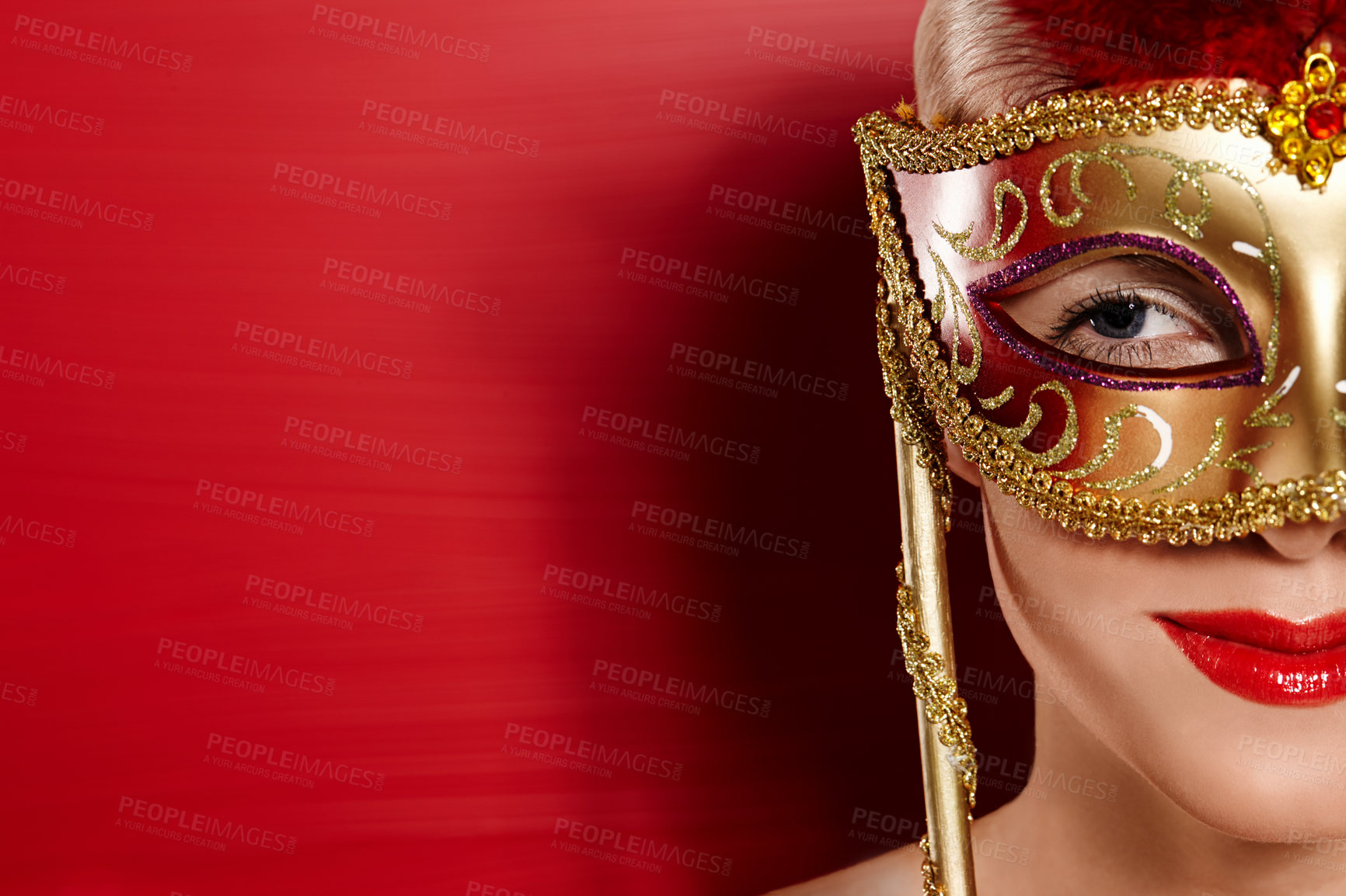 Buy stock photo Portrait, smile and woman in carnival mask for fun, art deco and dress up by red background. Happiness, female person and mysterious or playful with confidence for mockup in studio with lipstick