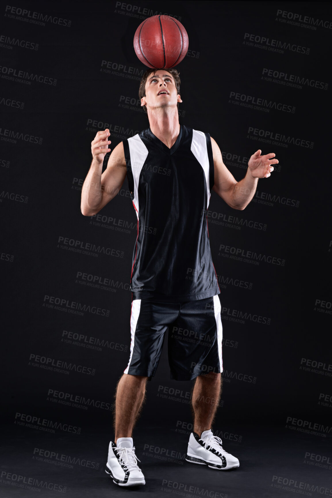 Buy stock photo Sports, man and basketball player with ball for balance training and skill exercise isolated in studio. Fitness, male person and athlete for goofy practice and joke warm up on black background