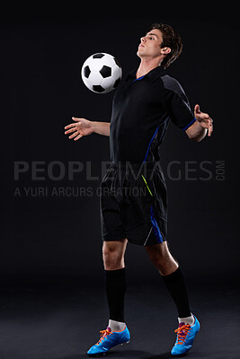 Buy stock photo Football, man and skill for fitness in studio for sports training with exercise isolated on black background. Talent, technique and male athlete with control in soccer kit with healthy professional.