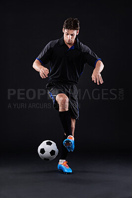 Buy stock photo Fitness, skill and football with man in studio for recreational sports training isolated on black background. Athlete, technique and talent with control in soccer kit with juggling tricks in Hungary.