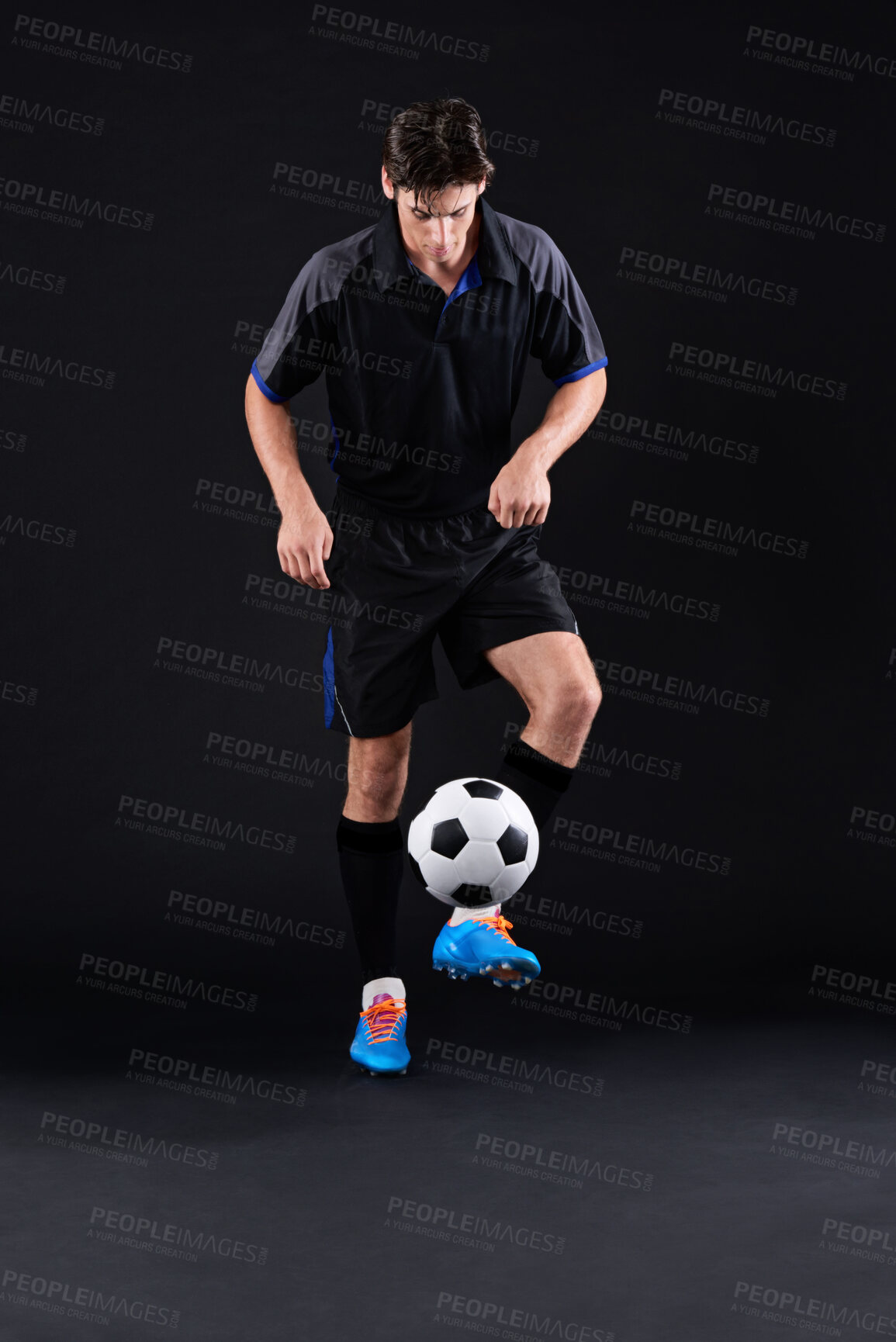 Buy stock photo Skill, fitness and football with man in studio as sports player training isolated on black background. Technique, athlete and talent with control in soccer kit with juggling tricks in Hungary.