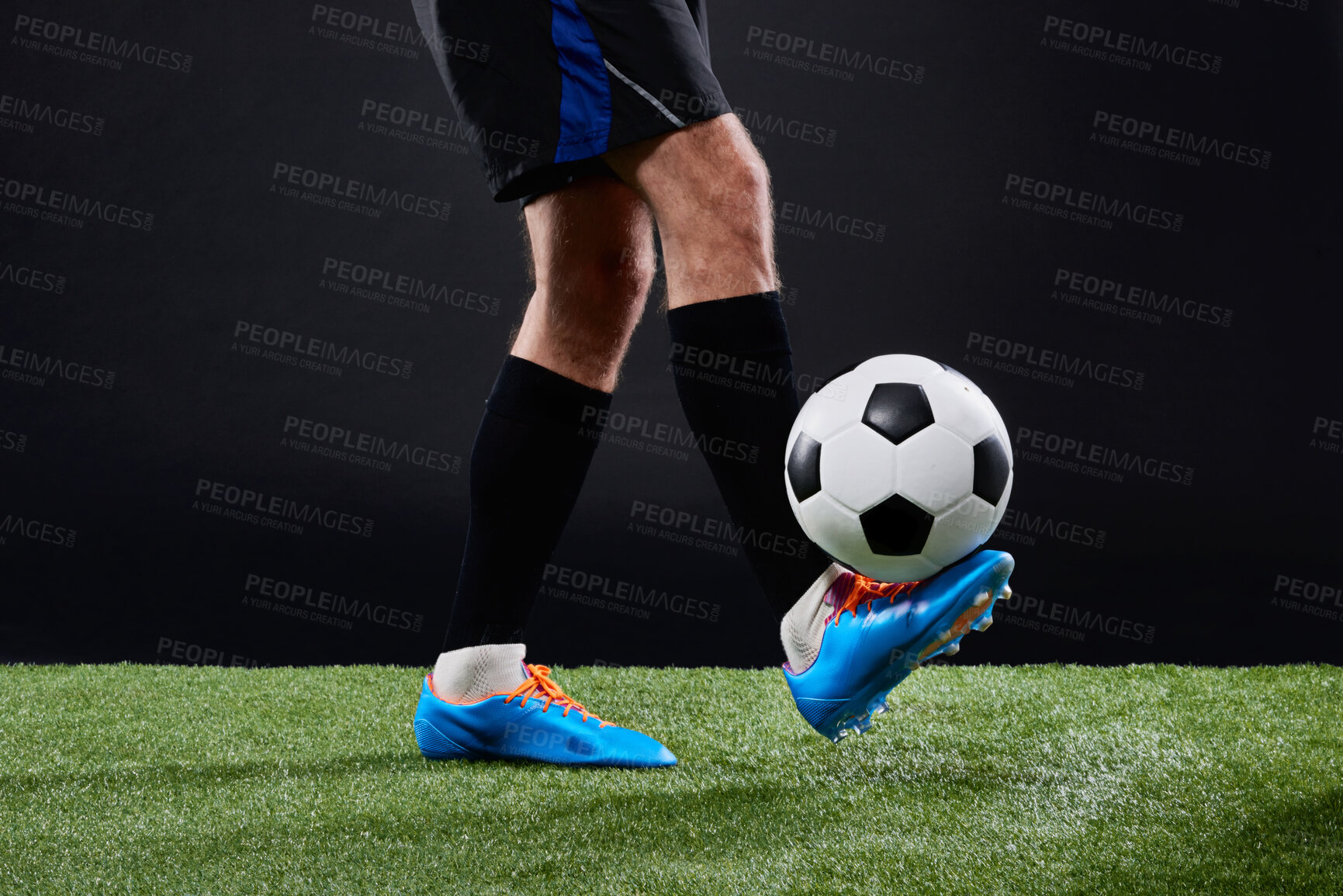 Buy stock photo Field, soccer player and foot with ball for balance, game and action for practice with shoes. Black background, athlete and person with talent for football, outdoor and fitness for sport and goal