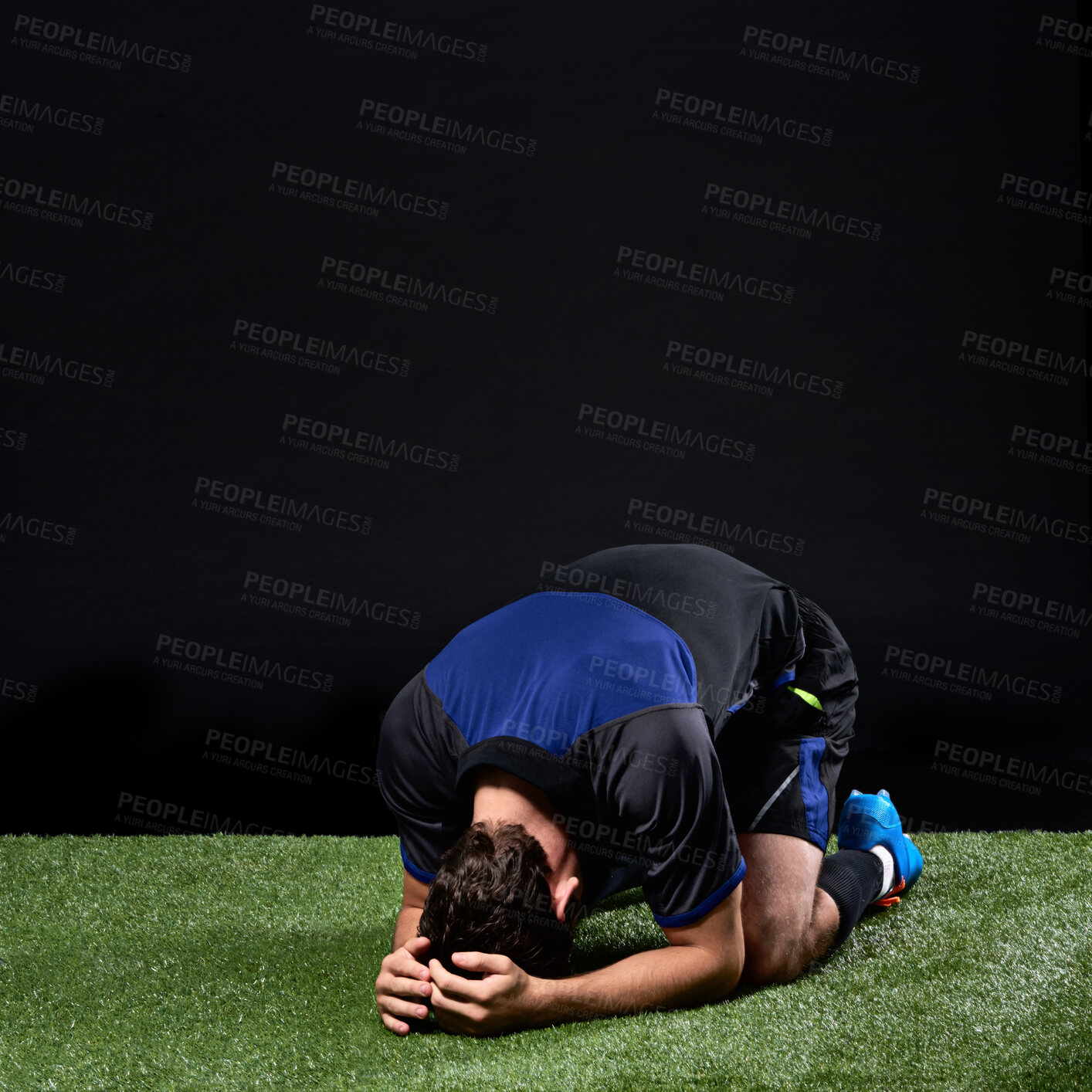 Buy stock photo Field, soccer player and man in grass, fail and frustrated in game, stress and upset on ground in studio. Black background, sad and athlete with depression, unhappy and person with loss in football