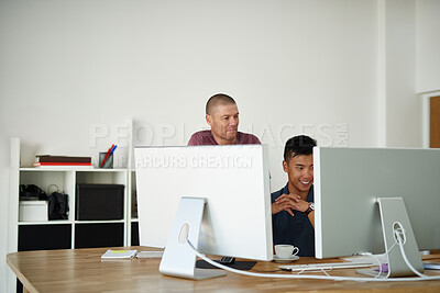 Buy stock photo Cropped shot of two designers working together on a project in an office