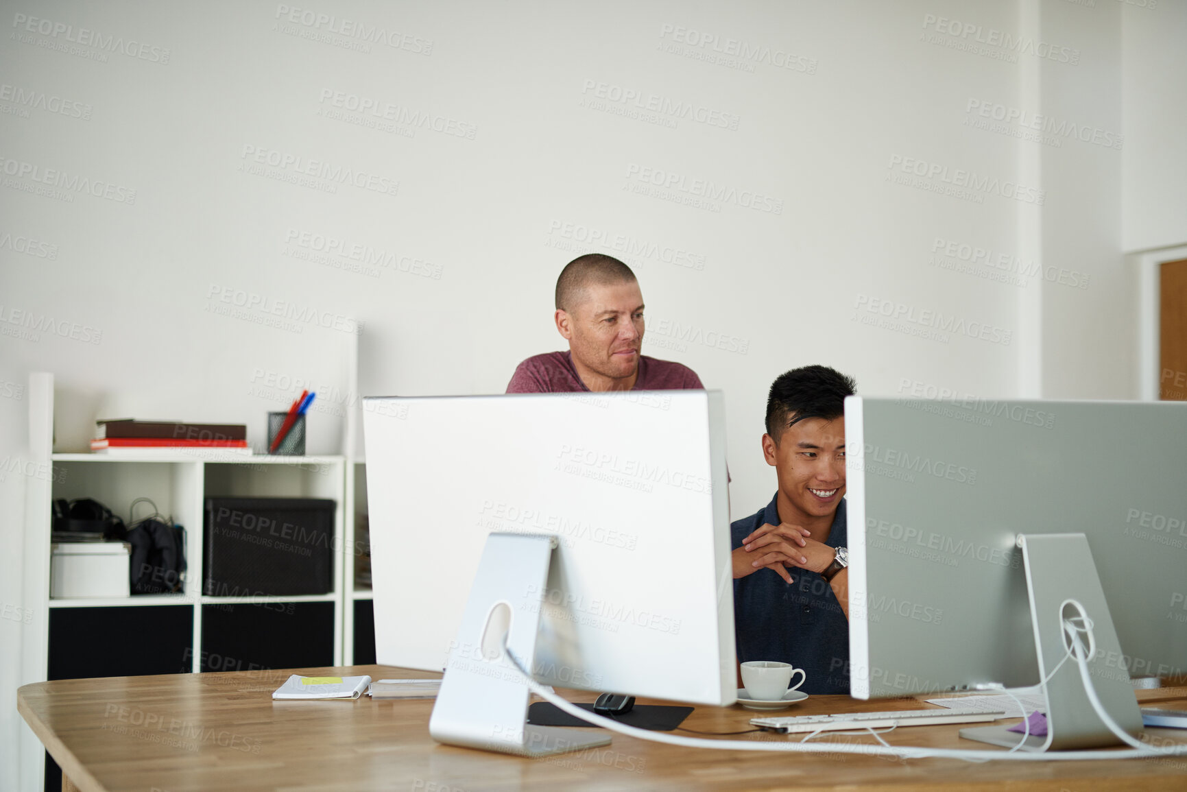 Buy stock photo Cropped shot of two designers working together on a project in an office