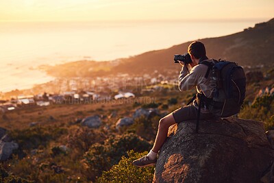 Buy stock photo Photography, nature and man on mountain with camera, memories and adventure for hiking. Professional photographer, outdoor and backpack on cliff with tech, creativity and view of sunset in Brazil