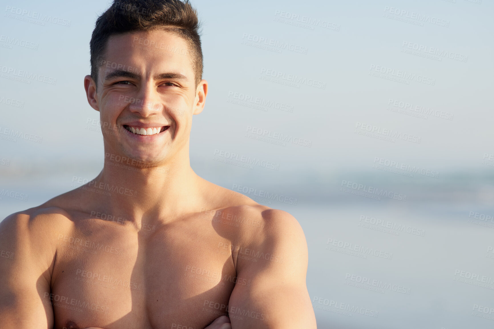 Buy stock photo Fitness, happy and portrait of man on beach for workout, exercise and training outdoors for surfing. Nature, crossed arms and confident person by space and ocean for wellness, health and water sports