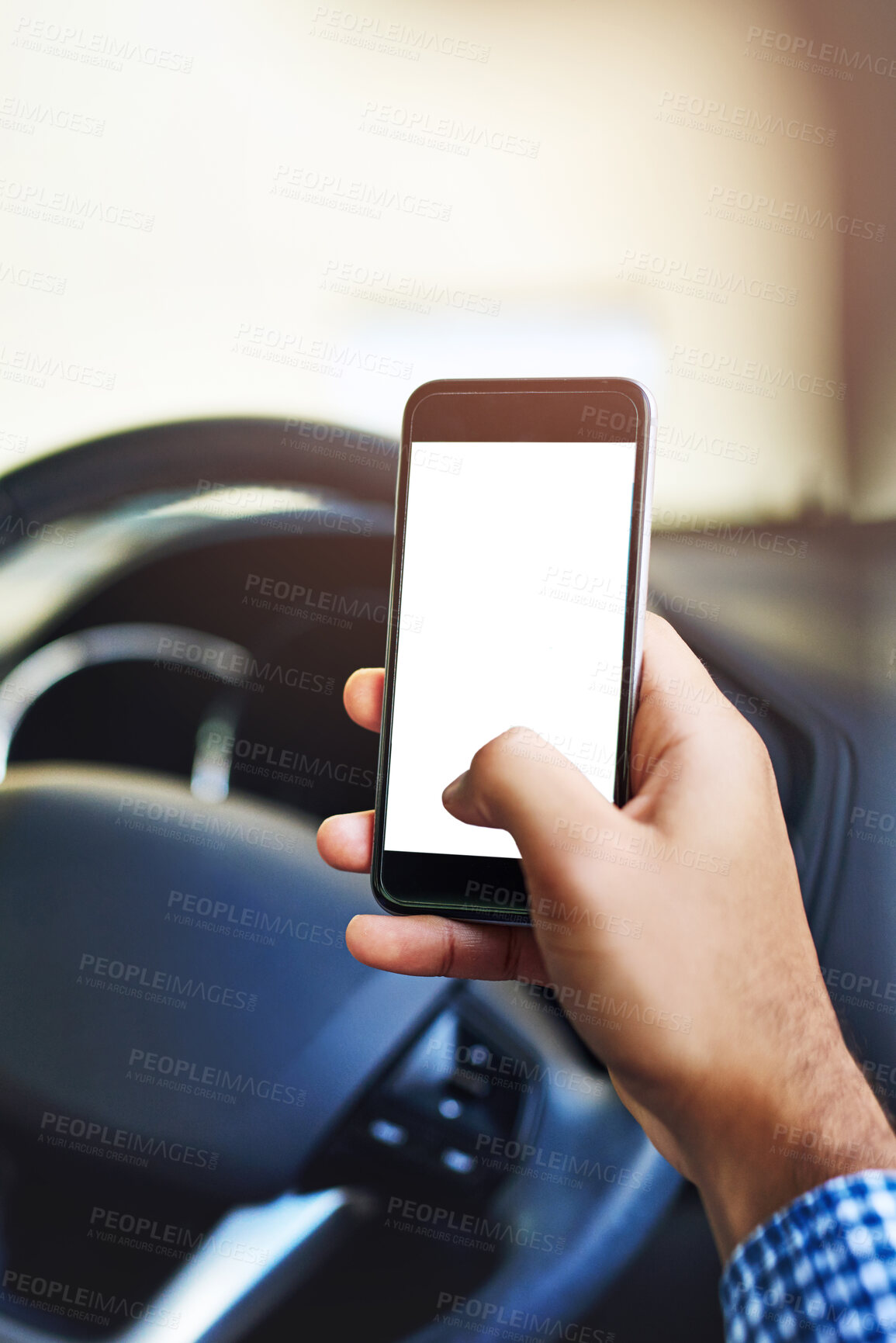 Buy stock photo Cropped shot of an unidentifiable man using a cellphone while driving a car