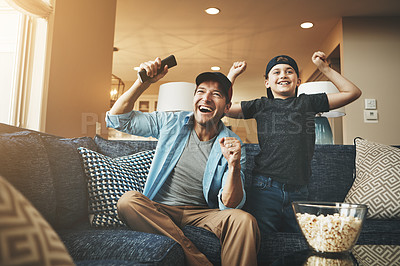 Buy stock photo Television, popcorn and man with kid in celebration for broadcast, subscription and bonding at home. Father, son and happy with tv remote in fist for sports, success or watching live network together