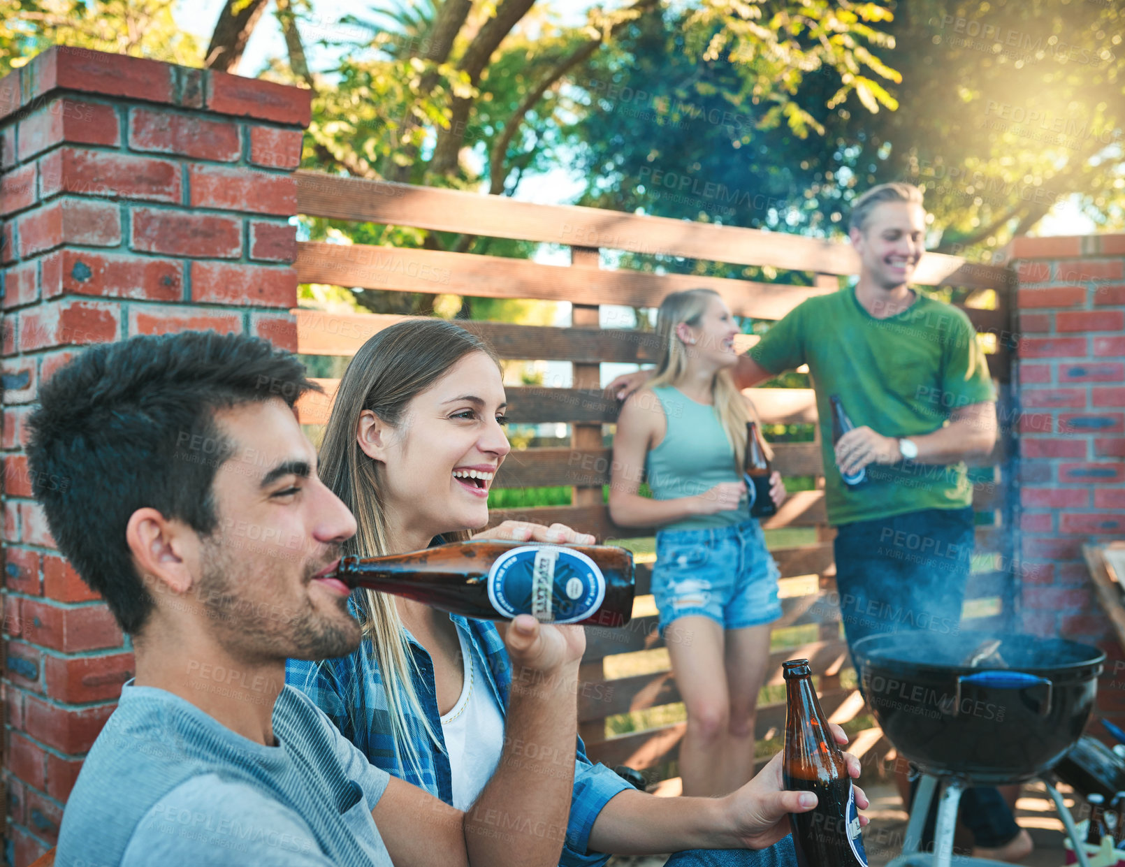 Buy stock photo Couple of friends, beer and outdoor barbecue, party or celebration of holiday with social hangout in backyard patio. Group of people with beverage, drinks or alcohol bottle for bbq and happy at home