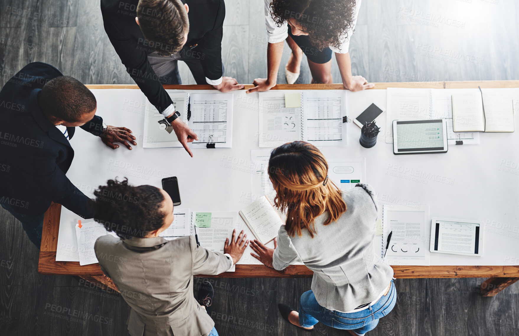 Buy stock photo High angle shot of a group of businesspeople having a meeting in an office