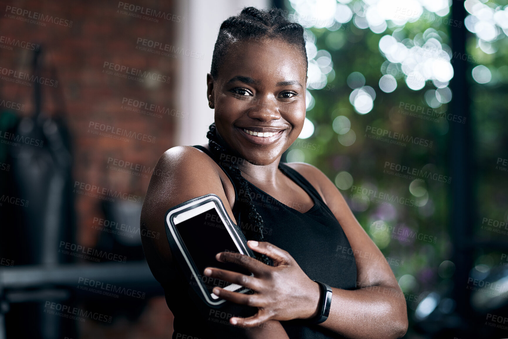 Buy stock photo Black woman, armband and cellphone for fitness, music and confidence for sports workout. Portrait, tracking app and internet for heart rate monitor, active and points online for African person in gym