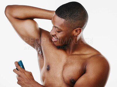 Buy stock photo Black man, deodorant and happy in studio for hygiene, body care and product for armpit odor. Skin, male model and cleaning or wellness with spray and cosmetics by white background for morning  