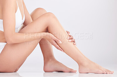 Buy stock photo Legs, hands and woman in studio for hair removal, epilation and natural beauty of body isolated on white background. Feet, touch and skincare of model waxing in underwear for dermatology or cosmetics