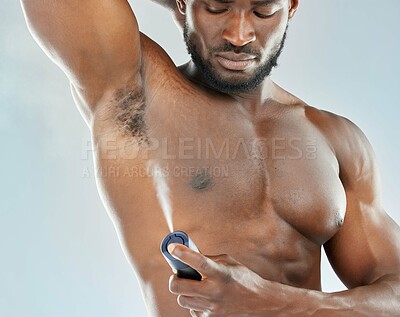 Buy stock photo Deodorant, spray and black man in studio for beauty, grooming and body hygiene on blue background. Skin, health and male spraying aerosol, fragrance and scent product for underarm care treatment