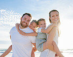 Happy family at  the beach. Portrait of smiling young parents with children having fun on vacation. Little boy and girl enjoying summer with mother and father