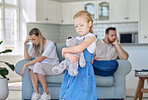 An upset little girl squeezing her teddy bear while looking sad and depressed while her parents argue in the background. Thinking about her parents breaking up or getting divorced is causing stress