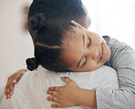 Closeup adorable little girl smiling and hugging her single father inside at home. Cute mixed race child enjoying weekend free time with single parent. Hispanic man bonding and holding his daughter