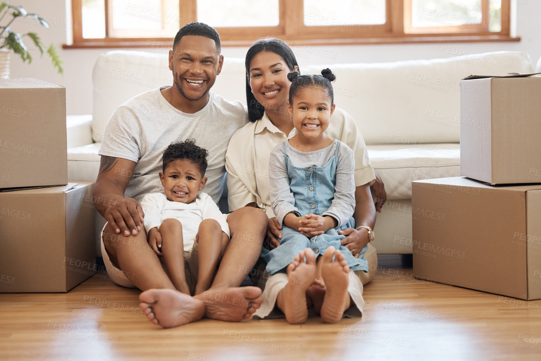 Buy stock photo New house, portrait and family on floor with moving box, hug and support, pride and security. Mortgage, real estate or children with happy parents in dream home success, property or future investment