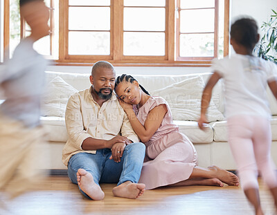 Buy stock photo Fatigue, African parents and adhd kids in lounge with stress, burnout and frustrated in home. Energy, movement and family on floor headache, tired and together with children in living room on weekend